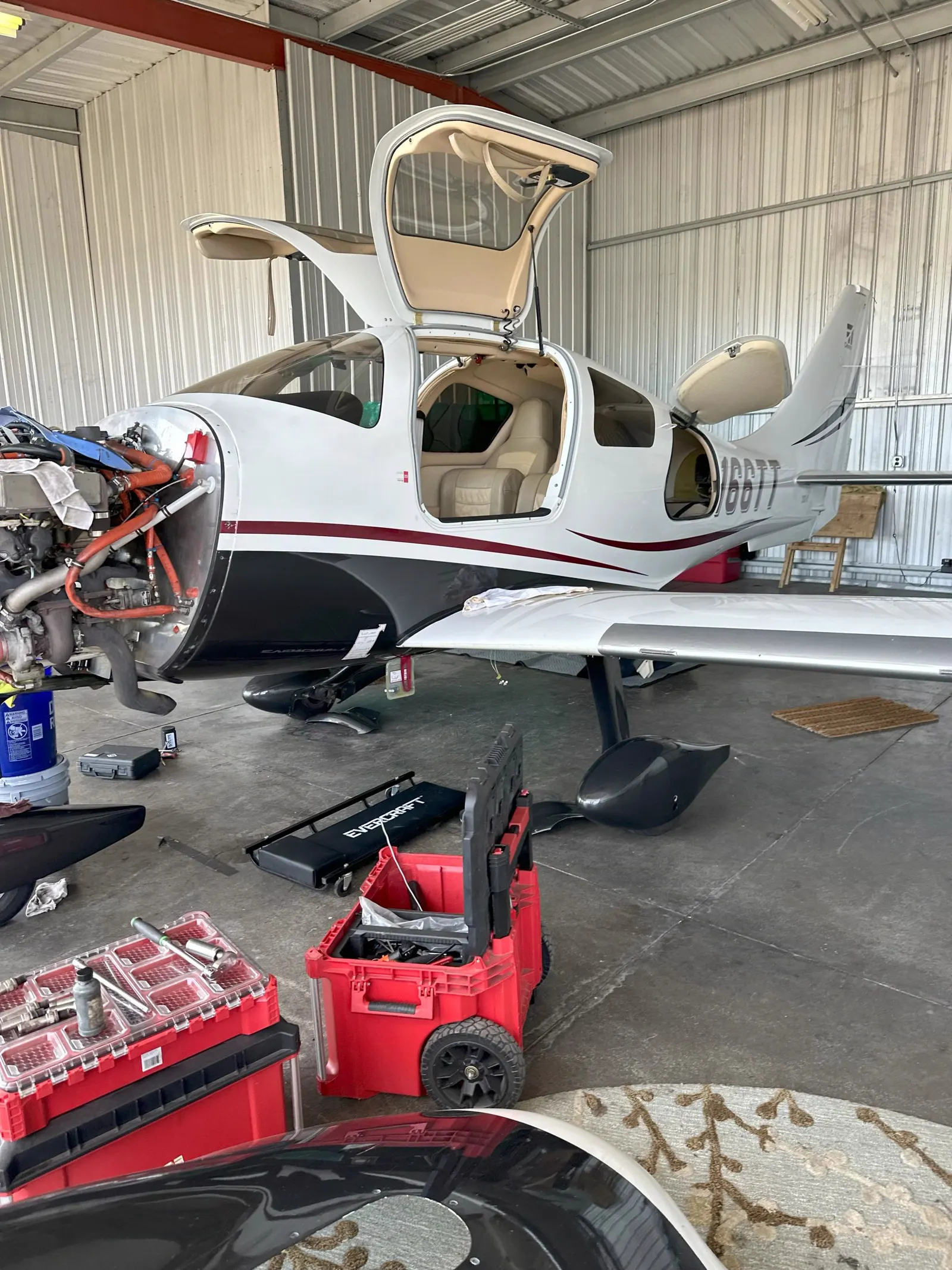 Cirrus aircraft on jacks for an annual inspection inside the Alpha Company Aviation maintenance shop in the Southeast
